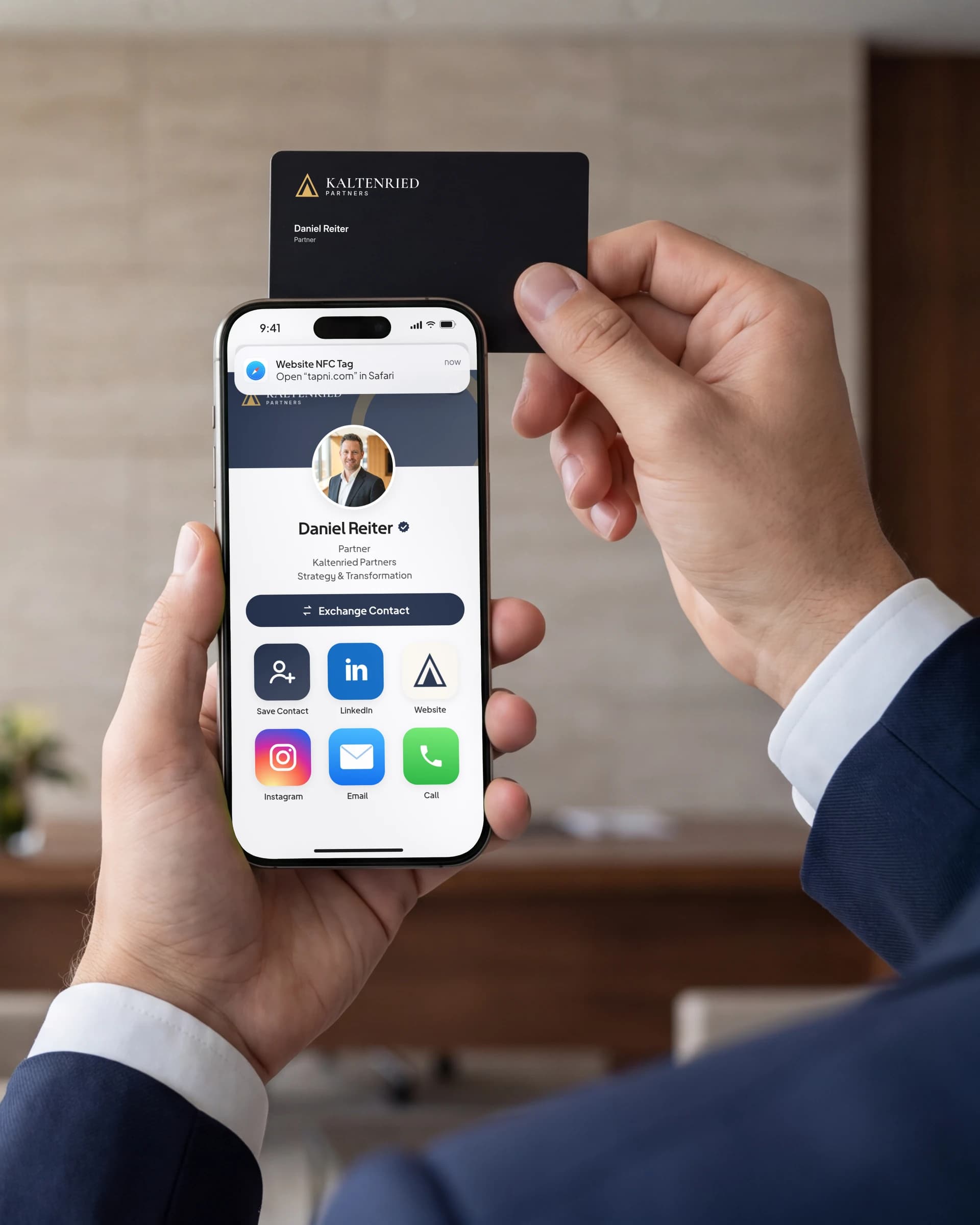 Hand holding a Tapni NFC business card beside a smartphone showing a digital profile in a modern office